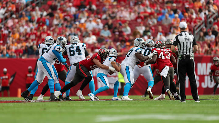 Dec 29, 2024; Tampa, Florida, USA; Tampa Bay Buccaneers defensive end Logan Hall (90) sacks Carolina Panthers quarterback Bryce Young (9) in the fourth quarter at Raymond James Stadium. Mandatory Credit: Nathan Ray Seebeck-Imagn Images