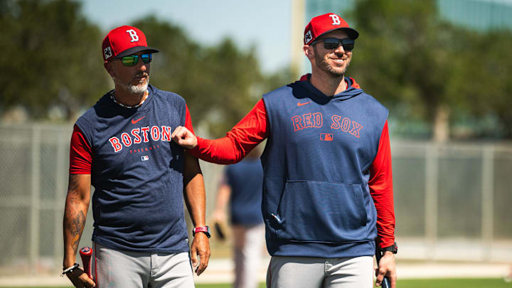 Boston Red Sox first base coach Jose Flores (left) and WooSox manager Chad Tracy walk on the back fields at JetBlue Park in Fort Myers, Florida on March 12, 2025.