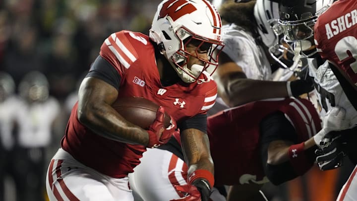 Nov 16, 2024; Madison, Wisconsin, USA;  Wisconsin Badgers running back Tawee Walker carries the ball against the Oregon Ducks.