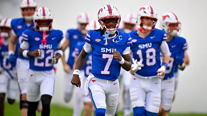 SMU quarterback Kevin Jennings (7) leads his team onto the field SMU quarterback Kevin Jennings (7) leads his team onto the field
