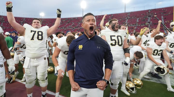 Nov 30, 2024; Los Angeles, California, USA; Notre Dame Fighting Irish head coach Marcus Freeman celebrates with players at the end of the game against the Southern California Trojans at United Airlines Field at Los Angeles Memorial Coliseum. Mandatory Credit: Kirby Lee-Imagn Images
