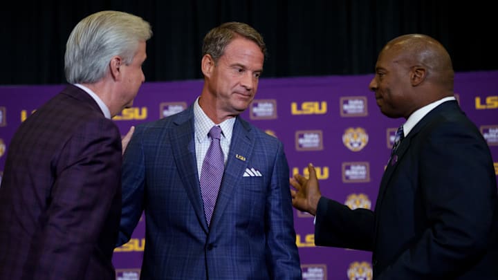 Dec 1, 2025; Baton Rouge, LA, USA; LSU president Wade Rousse, left, LSU new head coach Lane Kiffin, and LSU athletic director Verge Ausberry greet each other at South Stadium Club at Tiger Stadium. Mandatory Credit: Matthew Hinton-Imagn Images Dec 1, 2025; Baton Rouge, LA, USA; LSU president Wade Rousse, left, LSU new head coach Lane Kiffin, and LSU athletic director Verge Ausberry greet each other at South Stadium Club at Tiger Stadium. Mandatory Credit: Matthew Hinton-Imagn Images