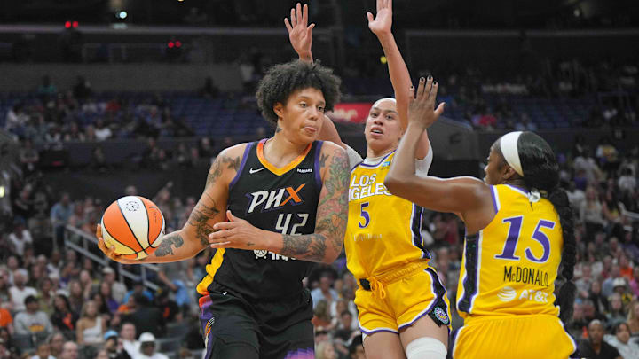 Jul 7, 2024; Los Angeles, California, USA; Phoenix Mercury center Brittney Griner (42) passes the ball against LA Sparks guard Aari McDonald (15) and forward Dearica Hamby (5) in the first half at Crypto.com Arena. Mandatory Credit: Kirby Lee-Imagn Images