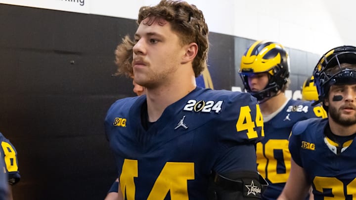 Hayden Moore heads for the field with his then Michigan teammates for the CFP title game against Washington. 
