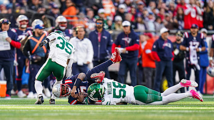 Oct 27, 2024; Foxborough, Massachusetts, USA; New England Patriots quarterback Jacoby Brissett (7) runs the ball against New York Jets linebacker Quincy Williams (56) in the second half  at Gillette Stadium. Mandatory Credit: David Butler II-Imagn Images