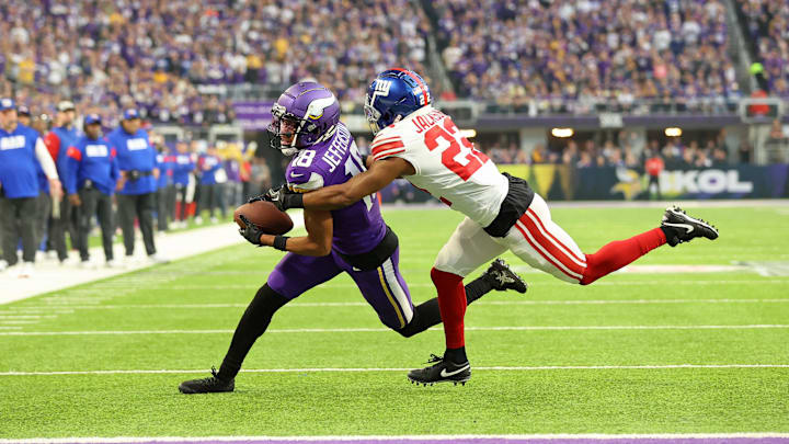 Jan 15, 2023; Minneapolis, Minnesota, USA; Minnesota Vikings wide receiver Justin Jefferson (18) runs with the ball after making a catch while defended by New York Giants cornerback Adoree' Jackson (22) during the first quarter of a wild card game at U.S. Bank Stadium. Jan 15, 2023; Minneapolis, Minnesota, USA; Minnesota Vikings wide receiver Justin Jefferson (18) runs with the ball after making a catch while defended by New York Giants cornerback Adoree' Jackson (22) during the first quarter of a wild card game at U.S. Bank Stadium.