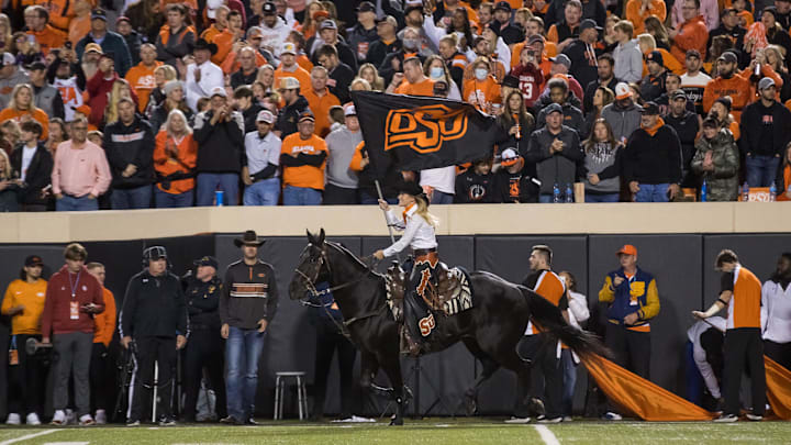 Nov 27, 2021; Stillwater, Oklahoma, USA;  Oklahoma State Cowboys    Spirit Rider    rides    Bullet    after a Cowboys touchdown during the first quarter against the Oklahoma Sooners at Boone Pickens Stadium. Oklahoma State Cowboys won 37-33. Mandatory Credit: Brett Rojo-Imagn Images