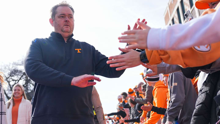 Tennessee coach Josh Heupel high-fives fans at the Vol Walk before a NCAA football game between Tennessee and Vanderbilt at Neyland Stadium in Knoxville, Tenn., on Nov. 29, 2025.