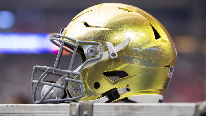 Jan 1, 2022; Glendale, Arizona, USA; Detailed view of a gold Notre Dame Fighting Irish helmet during the 2022 Fiesta Bowl at State Farm Stadium. Jan 1, 2022; Glendale, Arizona, USA; Detailed view of a gold Notre Dame Fighting Irish helmet during the 2022 Fiesta Bowl at State Farm Stadium.