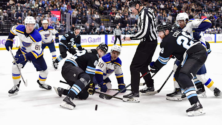 Jan 18, 2025; Salt Lake City, Utah, USA; Utah Hockey Club center Kevin Stenlund (82) and St. Louis Blues center Brayden Schenn (10) face-off during third period at the Delta Center. Mandatory Credit: Christopher Creveling-Imagn Images