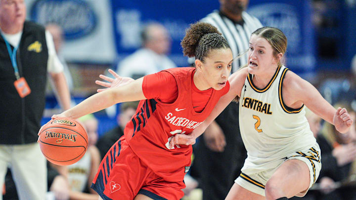 Sacred Heart's Brianna Wilkins (21) looks to drive past Johnson Central's Allie Slone (2) battle for control in the first half Thursday during the 2025 Clark’s Pump-N-Shop Girls’ Basketball Sweet 16 in Rupp Arena in Lexington, Kentucky. March 13, 2025 Sacred Heart's Brianna Wilkins (21) looks to drive past Johnson Central's Allie Slone (2) battle for control in the first half Thursday during the 2025 Clark’s Pump-N-Shop Girls’ Basketball Sweet 16 in Rupp Arena in Lexington, Kentucky. March 13, 2025