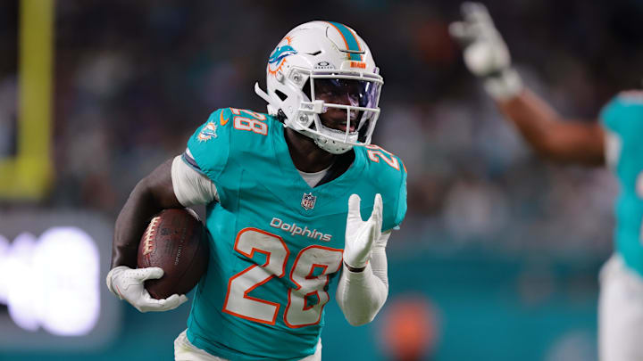 Oct 30, 2025; Miami Gardens, Florida, USA; Miami Dolphins running back De'Von Achane (28) runs for a gain during the first quarter against the Baltimore Ravens at Hard Rock Stadium. 