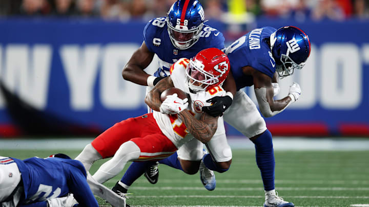 Sep 21, 2025; East Rutherford, New Jersey, USA; New York Giants inside linebacker Bobby Okereke (58) and safety Jevon Holland (8) and cornerback Paulson Adebo (21) tackle Kansas City Chiefs wide receiver Nikko Remigio (81) in the second quarter at MetLife Stadium. Mandatory Credit: Vincent Carchietta-Imagn Images