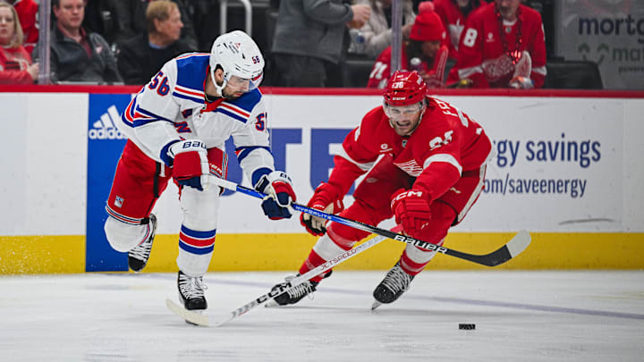 Apr 5, 2024; Detroit, Michigan, USA; New York Rangers defenseman Erik Gustafsson (56) and Detroit Red Wings right wing Christian Fischer (36) battle for the puck during the second period at Little Caesars Arena. Mandatory Credit: Tim Fuller-Imagn Images