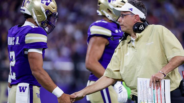 Huskies coach Jedd Fisch shakes hands with quarterback Demond Williams Jr. Huskies coach Jedd Fisch shakes hands with quarterback Demond Williams Jr.