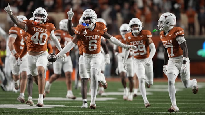 Texas Longhorns defensive back Kobe Black (6) and teammates react after making an interception during the second half.