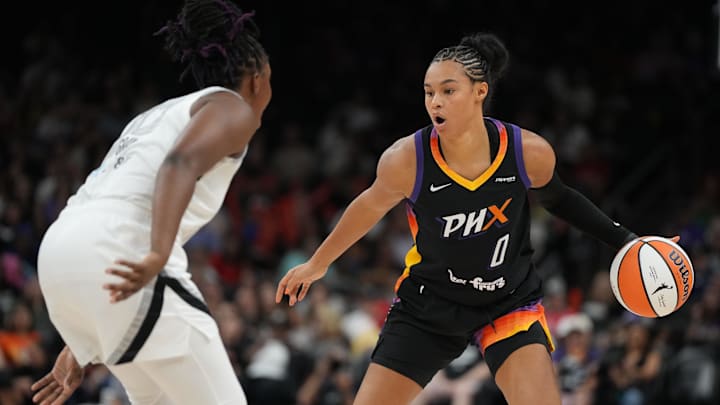 Aug 15, 2025; Phoenix, Arizona, USA; Phoenix Mercury forward Satou Sabally (0) drives on Las Vegas Aces guard Chelsea Gray (12) in the second half at Footprint Center. Mandatory Credit: Rick Scuteri-Imagn Images