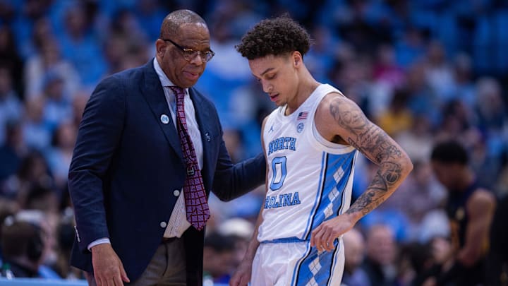 Dec 22, 2025; Chapel Hill, North Carolina, USA; North Carolina Tar Heels head coach Hubert Davis talks with guard Kyan Evans (0) during the first half against the East Carolina Pirates at Dean E. Smith Center. Mandatory Credit: Scott Kinser-Imagn Images