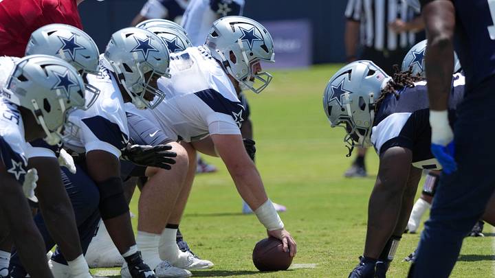 A general view of helmets at the line of scrimmage as Dallas Cowboys center Cooper Beebe snaps the ball at training camp A general view of helmets at the line of scrimmage as Dallas Cowboys center Cooper Beebe snaps the ball at training camp