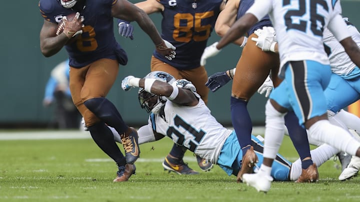 Nov 2, 2025; Green Bay, Wisconsin, USA; Green Bay Packers running back Josh Jacobs (8) slips away from Carolina Panthers safety Nick Scott (21) during the game at Lambeau Field.