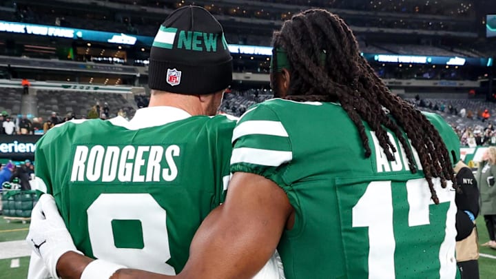 Jan 5, 2025; East Rutherford, New Jersey, USA; New York Jets quarterback Aaron Rodgers (8) and wide receiver Davante Adams (17) walk on the field after the Jets win over the Miami Dolphins at MetLife Stadium. Mandatory Credit: Ed Mulholland-Imagn Images