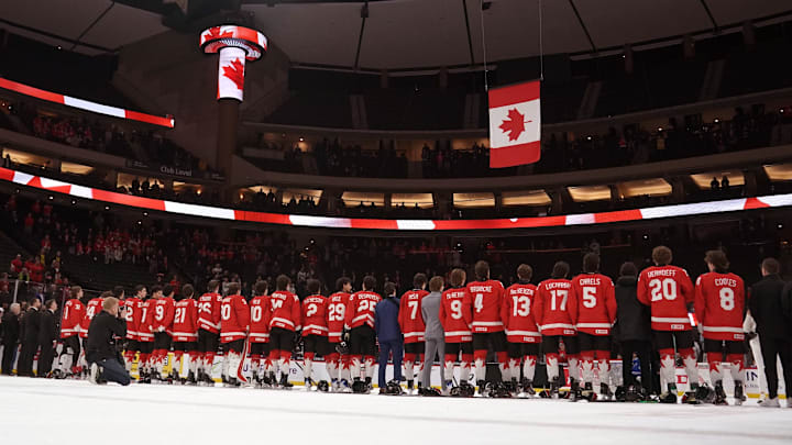 Jan 5, 2026; St. Paul, Minnesota, USA; Canada watches as their flag is raised and their national anthem is played for defeating Finland in the third place game of the 2026 IIHF World Junior Championship ice hockey tournament at Grand Casino Arena. Mandatory Credit: Nick Wosika-Imagn Images