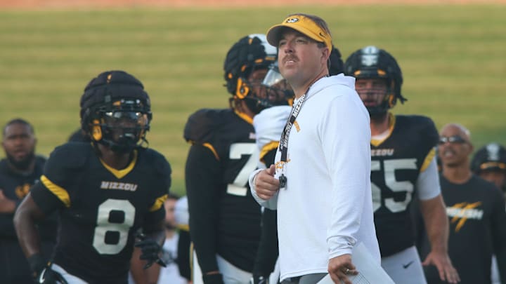 Aug.17, 2024; Columbia, Missouri, USA; Missouri Tigers head coach Eli Drinkwitz looks onto the practice field at the team's annual fan night practice at Faurot Field.