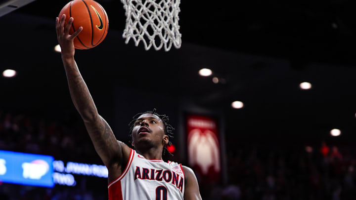 Feb 15, 2025; Tucson, Arizona, USA; Arizona Wildcats guard Jaden Bradley (0) makes a lay up while Houston Cougars guard L.J. Cryer (4) fails to block him during the second half at McKale Center. Mandatory Credit: Aryanna Frank-Imagn Images