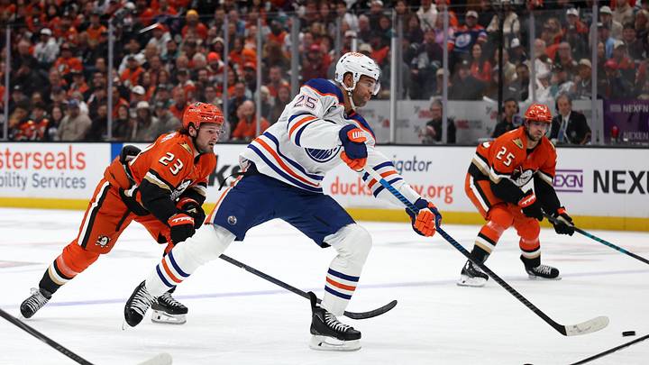 Apr 24, 2026; Anaheim, California, USA;  Edmonton Oilers defenseman Darnell Nurse (25) shoots the puck ahead of Anaheim Ducks center Mason McTavish (23) during the first period of game three of the first round of the 2026 Stanley Cup Playoffs at Honda Center. Mandatory Credit: Kiyoshi Mio-Imagn Images