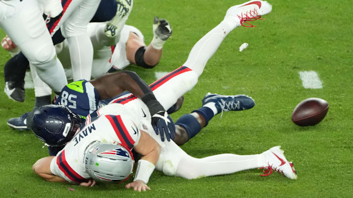 Feb 8, 2026; Santa Clara, CA, USA; New England Patriots quarterback Drake Maye (10) fumbles as he is sacked by Seattle Seahawks linebacker Derick Hall (58) in the second half in Super Bowl LX at Levi's Stadium. Mandatory Credit: Kirby Lee-Imagn Images