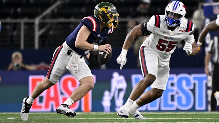 Jan 30, 2025; Arlington, TX, USA; East quarterback Cam Miller of North Dakota State (7) rolls out to avoid the rush of West edge rusher Elijah Roberts of SMU (55) during the first half at AT&T Stadium. Mandatory Credit: Jerome Miron-Imagn Images