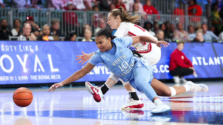 Nov 25, 2024; Paradise Island, Bahamas, BHS; North Carolina Tar Heels guard Reniya Kelly (10) and Indiana Hoosiers guard Shay Ciezki (10) go for a loose ball during the second half at the Atlantis Resort. Mandatory Credit: Kevin Jairaj-Imagn Images