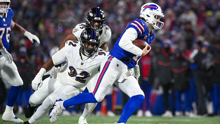 Jan 19, 2025; Orchard Park, New York, USA; Buffalo Bills quarterback Josh Allen (17) avoids a tackle by Baltimore Ravens defensive tackle Nnamdi Madubuike (92) to gain a first down in the first quarter of a 2025 AFC divisional round game at Highmark Stadium. Mandatory Credit: Mark Konezny-Imagn Images