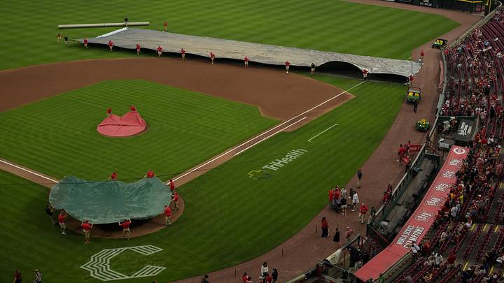 Jul 27, 2026; Cincinnati, Ohio, USA; Members of the grounds crew tend to the field as rain begins to fall, before the game between Cleveland Guardians and the Cincinnati Reds at Great American Ball Park. The game was postponed due to inclement weather. Mandatory Credit: Aaron Doster-Imagn Images Jul 27, 2026; Cincinnati, Ohio, USA; Members of the grounds crew tend to the field as rain begins to fall, before the game between Cleveland Guardians and the Cincinnati Reds at Great American Ball Park. The game was postponed due to inclement weather. Mandatory Credit: Aaron Doster-Imagn Images