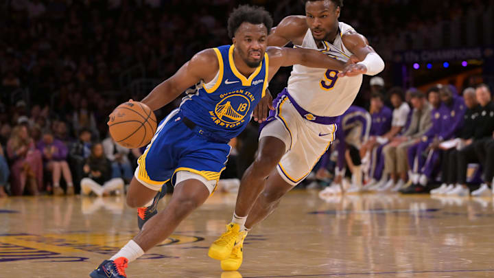 Oct 12, 2025; Los Angeles, California, USA;  Golden State Warriors guard LJ Cryer (18) is defended by Los Angeles Lakers guard Bronny James (9) as he drives to the basket during the second half at Crypto.com Arena.