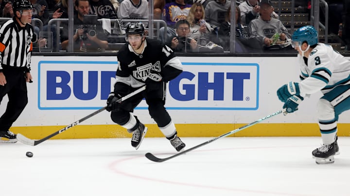 Oct 24, 2024; Los Angeles, California, USA; Los Angeles Kings right wing Alex Laferriere (14) looks to pass against San Jose Sharks defenseman Henry Thrun (3) during the second period at Crypto.com Arena. Mandatory Credit: Jason Parkhurst-Imagn Images