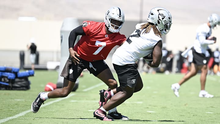 Las Vegas Raiders quarterback Geno Smith (7) hands the ball to running back Ashton Jeanty (2) during Las Vegas Raiders Minicamp at Intermountain Health Performance Center. Las Vegas Raiders quarterback Geno Smith (7) hands the ball to running back Ashton Jeanty (2) during Las Vegas Raiders Minicamp at Intermountain Health Performance Center.