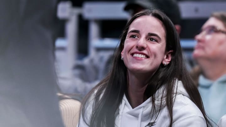 Indiana Fever guard Caitlin Clark (22) smiles Thursday, March 6, 2025, in a round two game at the 2025 TIAA Big Ten Women's Basketball Tournament between the Iowa Hawkeyes and the Michigan State Spartans at Gainbridge Fieldhouse in Indianapolis.
