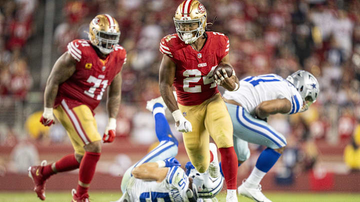 October 8, 2023; Santa Clara, California, USA; San Francisco 49ers running back Jordan Mason (24) runs past Dallas Cowboys linebacker Leighton Vander Esch (55) and linebacker Micah Parsons (11) during the fourth quarter at Levi's Stadium. Mandatory Credit: Kyle Terada-Imagn Images