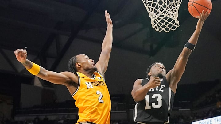 Feb 10, 2024; Columbia, Missouri, USA; Mississippi State Bulldogs guard Josh Hubbard (13) shoots as Missouri Tigers guard Tamar Bates (2) defends during the second half at Mizzou Arena. Mandatory Credit: Denny Medley-Imagn Images