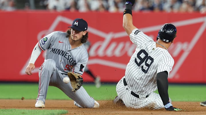 Aug 12, 2025; Bronx, New York, USA; New York Yankees designated hitter Aaron Judge (99) steals second base as Minnesota Twins third baseman Ryan Fitzgerald (53) catches the throw during the fourth inning at Yankee Stadium.