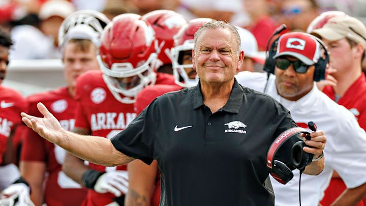 Arkansas Razorback head coach Sam Pittman (front) and defensive line coach Deke Adams watch from the sidelines in Arkansas' 56-14 win over the Arkansas State Red Wolves at War Memorial Stadium in Little Rock