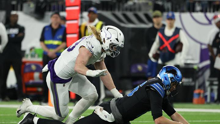 Dec 25, 2025; Minneapolis, Minnesota, USA; Detroit Lions quarterback Jared Goff (16) attempts to recover a fumble defended by Minnesota Vikings linebacker Andrew van Ginkel (43) in the second half at U.S. Bank Stadium. Ginkel recovered the fumble on the play.