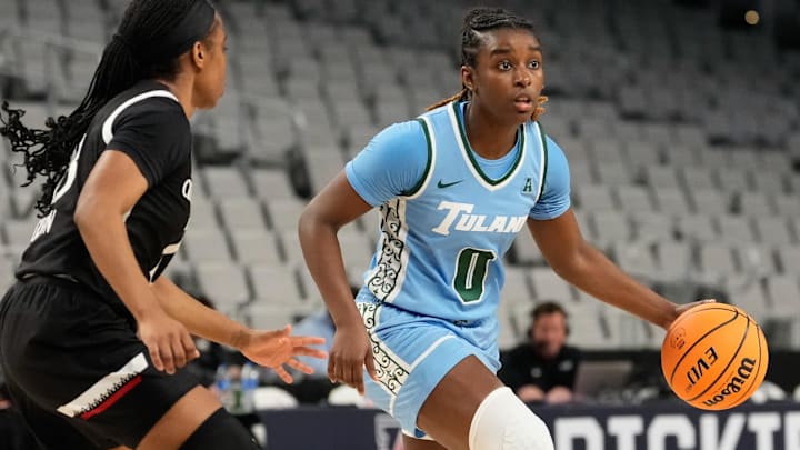 Mar 6, 2023; Fort Worth, TX, USA; Tulane Green Wave guard Kyren Whittington (0) controls the ball against Cincinnati Bearcats guard Mya Jackson (23) during the first half at Dickies Arena. Mar 6, 2023; Fort Worth, TX, USA; Tulane Green Wave guard Kyren Whittington (0) controls the ball against Cincinnati Bearcats guard Mya Jackson (23) during the first half at Dickies Arena.