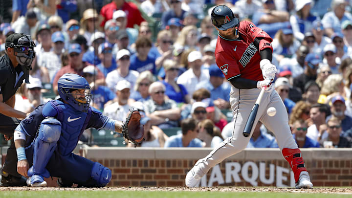 Jul 19, 2024; Chicago, Illinois, USA; Arizona Diamondbacks first baseman Christian Walker (53) hits a two-run single against the Chicago Cubs during the third inning at Wrigley Field. Mandatory Credit: Kamil Krzaczynski-Imagn Images