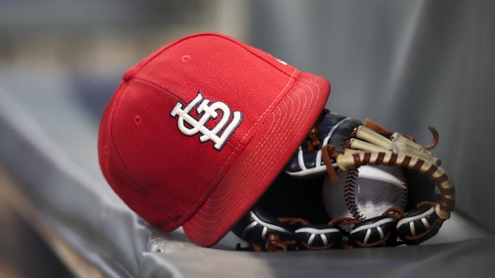 Sep 17, 2018; Atlanta, GA, USA; Detailed view of a St. Louis Cardinals hat and glove in the dugout against the Atlanta Braves in the first inning at SunTrust Park. Mandatory Credit: Brett Davis-Imagn Images
