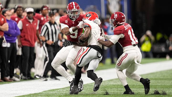 Dec 6, 2025; Atlanta, GA, USA; Georgia Bulldogs wide receiver Zachariah Branch (1) runs after making a catch and is tackled by Alabama Crimson Tide defensive back Cam Calhoun (9) and Alabama Crimson Tide linebacker Justin Jefferson (10) during the first quarter during the 2025 SEC Championship game at Mercedes-Benz Stadium. Mandatory Credit: Dale Zanine-Imagn Images