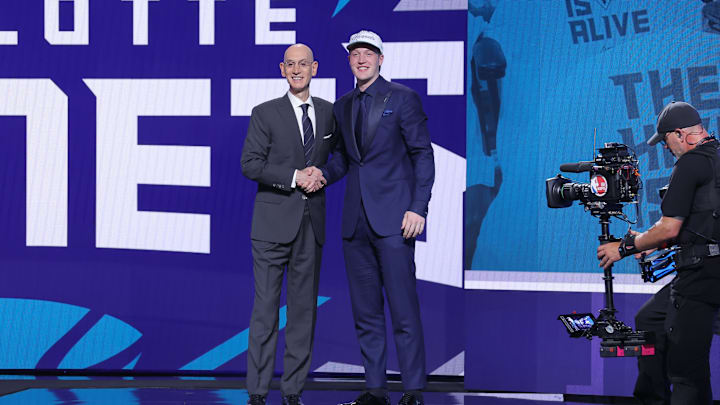 Kon Knueppel stands with NBA commissioner Adam Silver after being selected as the fourth pick 