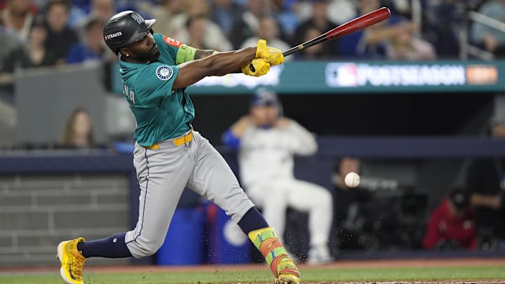 Oct 19, 2025; Toronto, Ontario, CAN; Seattle Mariners left fielder Randy Arozarena (56) hits a single against the Toronto Blue Jays in the fourth inning during game six of the ALCS round for the 2025 MLB playoffs at Rogers Centre. Mandatory Credit: John E. Sokolowski-Imagn Images