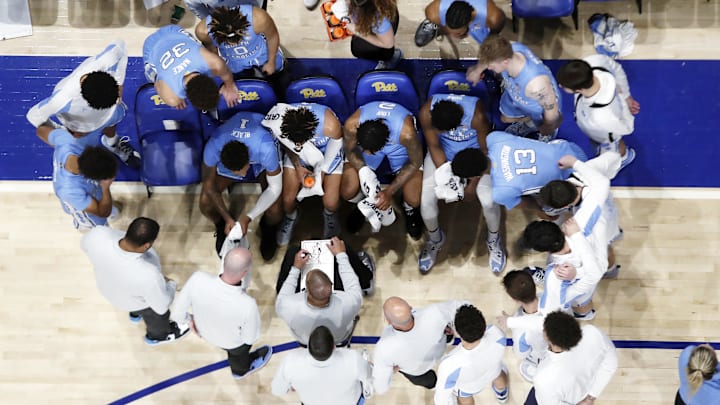 Dec 30, 2022; Pittsburgh, Pennsylvania, USA; North Carolina Tar Heels head coach Hubert Davis (with clipboard) diagrams a play in the huddle against the Pittsburgh Panthers during the second half at the Petersen Events Center. Pittsburgh won 76-74. Mandatory Credit: Charles LeClaire-Imagn Images